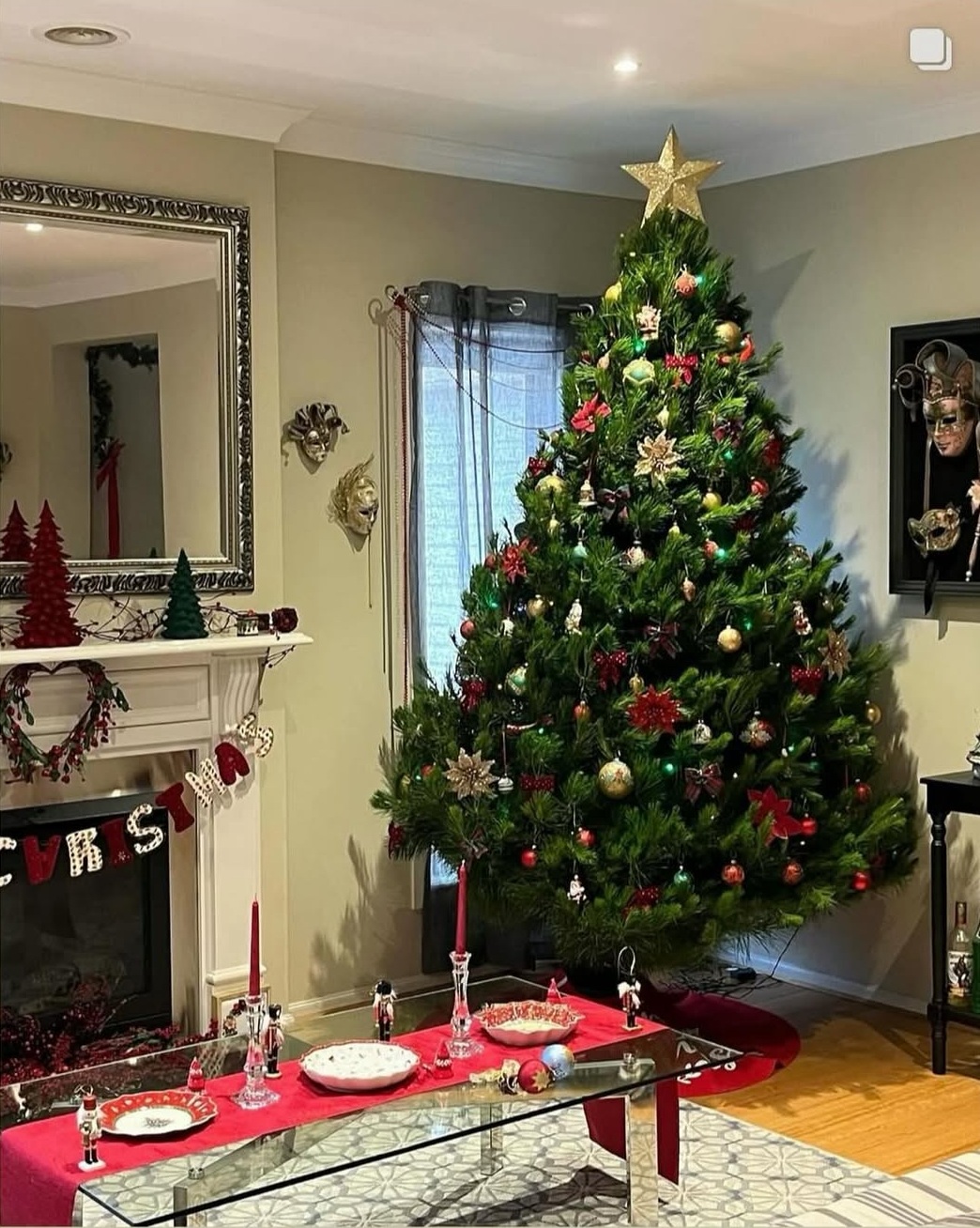 A decorated Christmas tree with a gold star in a festive living room